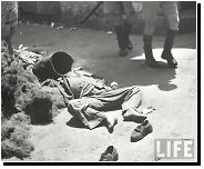 A 13-year-old Palestinian boy lies dead on streets of Haifa during the civil war in Mandatory Palestine. Passing by him are British soldiers in the process of withdrawing from the Mandate, April 1948 [640 x 855]. from haifa majic 13